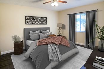 A bedroom with a bed and a ceiling fan